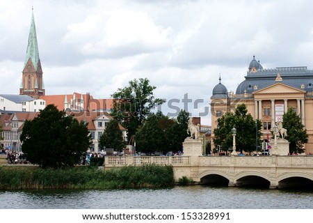 SCHWERIN, GERMANY - AUGUST 11: The Schwerin Castle Bridge with view of the Schwerin Cathedral and the State Theater on August 11, 2013 in Schwerin / Schwerin Castle Bridge