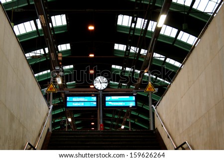 BERLIN, GERMANY - JANUARY 2: The staircase of a platform from the Berlin East railway station with a clock and displays on January 02, 2013 in Berlin / Berlin east railway station