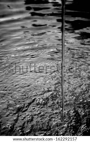 The photograph of a water jet in a fountain pool / Water jet