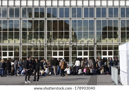 FRANKFURT, GERMANY - FEBRUARY 19: Young people sitting and waiting for entrance to the concert of the R & B singer Drake on February 19, 2014 in Frankfurt / Before the concert