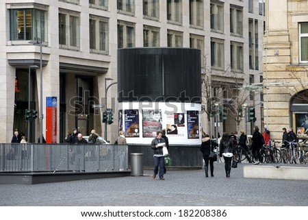 FRANKFURT, GERMANY - FEBRUARY 19: The park entrance of the Goethe parking place with a advertising column and passers-by on February 19, 2014 in Frankfurt