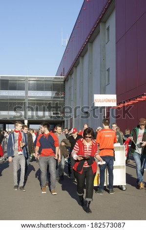MAINZ, GERMANY - MARCH 9: Fans of 1. FC Mainz 05 are going to a soccer match in the Co Face Arena on March 09, 2014 in Mainz / German soccer league
