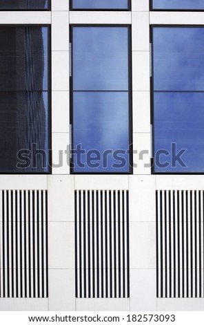 The facade of a modern house with tinted windows and grilles / Tinted windows and grid