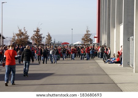 MAINZ, GERMANY - MARCH 9: Fans of the soccer club 1.FSV Mainz 05 going and waiting for entrance in front of the Co Face Arena on March 09, 2014 in Mainz / German Soccer league