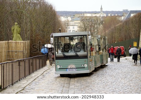 PARIS, FRANCE - DECEMBER 30: A shuttle bus transport tourists in the garden of the Palace of Versailles on December 30, 2013 in Paris / Shuttle bus Palace of Versailles