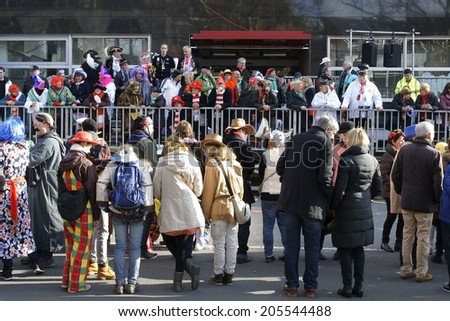 COLOGNE, GERMANY - MARCH 2: Colorful dressed people with masks and costumes await the carnival procession on March 02, 2014 in Cologne / Cologne carnival