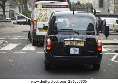 LONDON, UK - NOVEMBER 27: The rear view of a taxi in the City of Westminster, which holds on a pedestrian crossing on November 27, 2014 in London / Taxi in Westminster