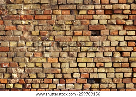 A striking wall of displaced and broken bricks / Striking brick wall