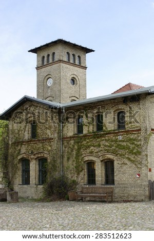 BERLIN, GERMANY - MAY 05: A manor house of brick with a clock tower in the estate park of the castle Britz on May 05, 2015 Germany / Manor Park Britz