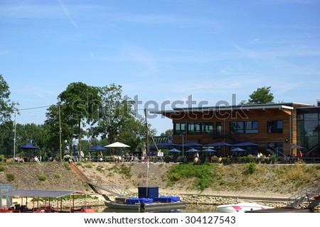 MAINZ, GERMANY - JULY 25: The Restaurant Boathouse on a summer day with guests which are sitting outside under umbrellas on July 25, 2015 in Mainz / Restaurant Boathouse Mainz
