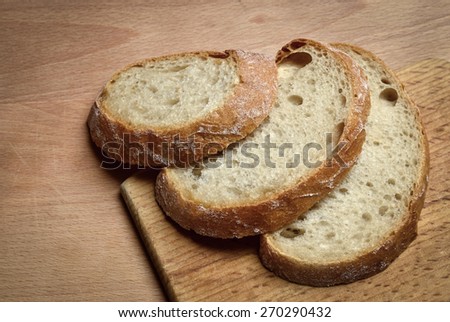 three slices of bread on wooden board beech