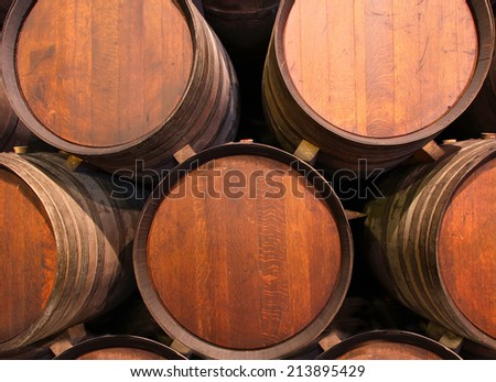 Row of wooden barrels of tawny portwine ( port wine ) in cellar, Porto, Portugal
