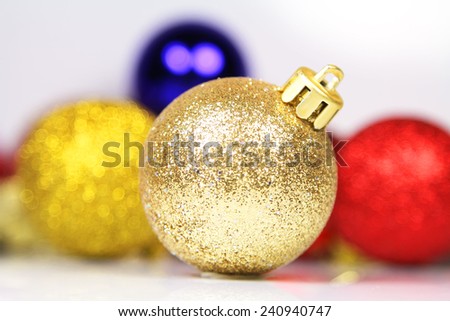 Christmas decorations. Yellow ball on blurred multicolored abstract background