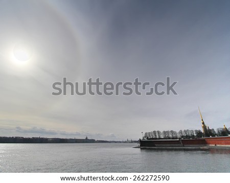 SAINT-PETERSBURG - MAR 20: Solar eclipse on March 20, 2015. Eclipse and corona in the sky. Silhouette of embankment of Neva river distorted by the wide lense in St. Petersburg, Russia.