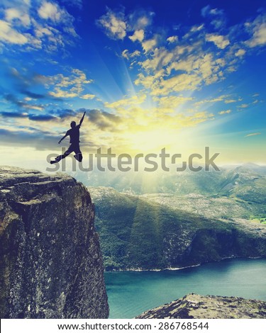 Silhouette of a man on a mountain top.Sport and active life concept