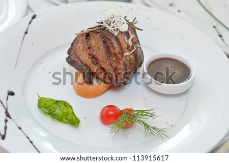 steak sauce garnished with dill and tomato