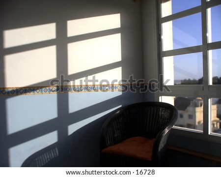 Black armchair close to a sunny window