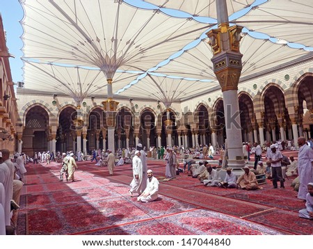 MEDINA, SAUDI ARABIA (KSA) - SEPTEMBER 9 : Muslims get ready to pray inside Nabawi Mosque September 9, 2010 in Medina, KSA. Beneath the green dome is where Prophet Muhammad is laid to rest.