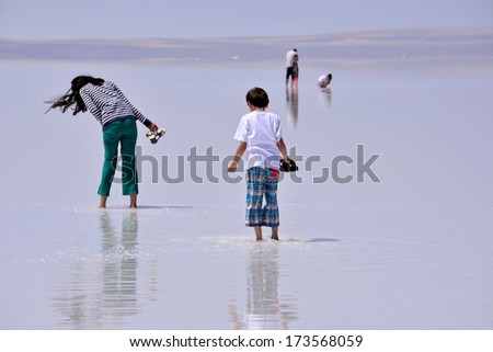 SALT LAKE, TURKEY - JULY 03: People walking at Salt Lake on July 03, 2013 in Aksaray, Turkey. Salt Lake is the second largest lake in Turkey