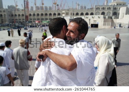 MECCA, SAUDI ARABIA - FEBRUARY 4: Two Muslims greet each other at the kaaba on February 4, 2015 in Mecca, Saudi Arabia. Muslim people praying together at holy place.