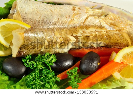 fish with lemon, vegetables and herbs