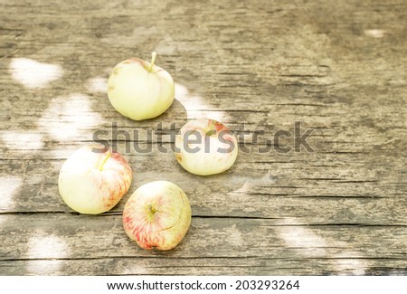 broken apples on an old wooden surface