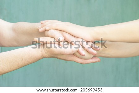 warm hands of a young girl and an old woman