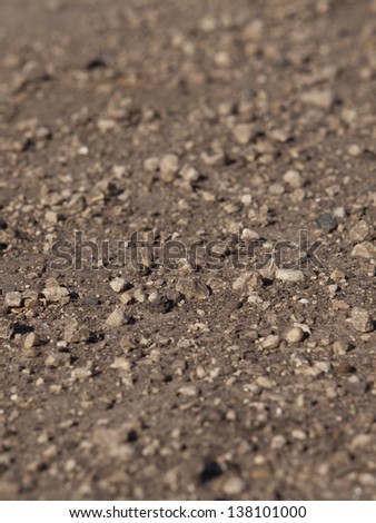 A pile of small stones lying on the ground. The natural composition