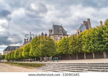 French Castle of Fontainebleau behind the trees
