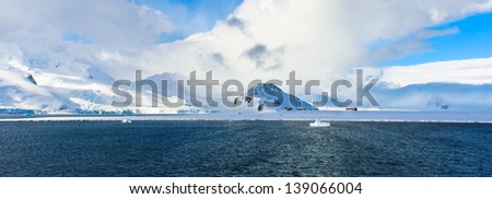 Clouds cover the snow rock of South Shetland Islands