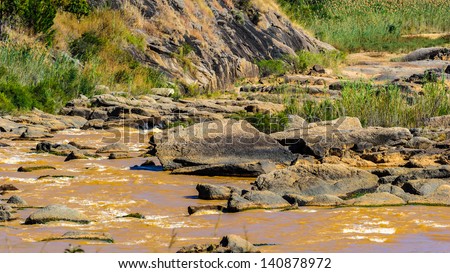 Small river runs over the stones