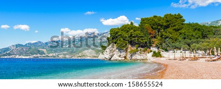Beautiful landscape of the rock and the transparent water of the sea and the yellow clean sand
