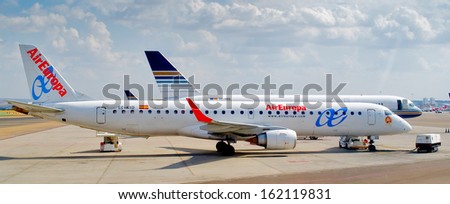 MADRID, SPAIN - SEPTEMBER 22, 2012: Two aircrafts paked in the Barajas airport in Madrid, Spain, on September 22, 2012.  Barajas is the main international airport serving Madrid in Spain.