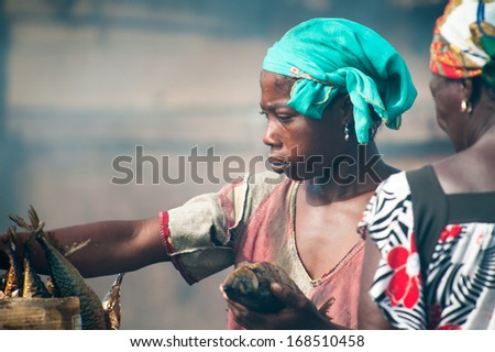 GHANA - MARCH 2, 2012: Unidentified Ghanaian woman works on a fish market in Ghana, on March 2nd, 2012. People in Ghana suffer from poverty due to the slow development of the country
