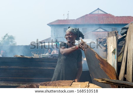 GHANA - MARCH 2, 2012: Unidentified Ghanaian woman works on a market in Ghana, on March 2nd, 2012. People in Ghana suffer from poverty due to the slow development of the country