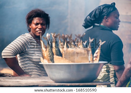 GHANA - MARCH 2, 2012: Unidentified Ghanaian woman works on a market in Ghana, on March 2nd, 2012. People in Ghana suffer from poverty due to the slow development of the country