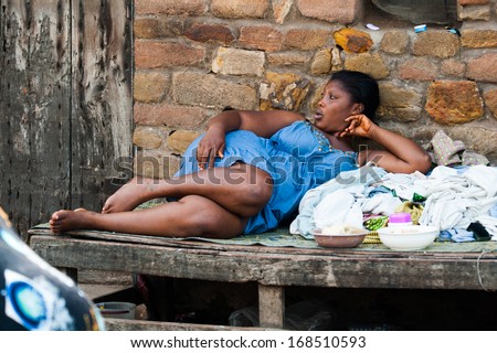 GHANA - MARCH 2, 2012: Unidentified Ghanaian woman takes a rest on a bench in Ghana, on March 2nd, 2012. People in Ghana suffer from poverty due to the slow development of the country