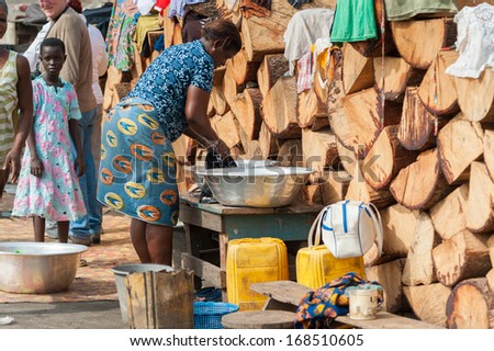 GHANA - MARCH 2, 2012: Unidentified Ghanaian woman washes the clothes in Ghana, on March 2nd, 2012. People in Ghana suffer from poverty due to the slow development of the country