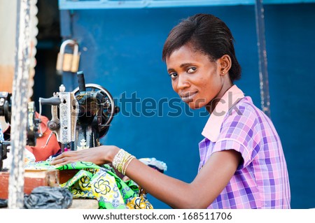 Ghana - March 2, 2012: Unindentified Ghanaian Woman Works With A Sewing Machine In Ghana, On March 2nd, 2012. People In Ghana Suffer From Poverty Due To The Slow Development Of The Country
