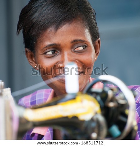 GHANA - MARCH 2, 2012: Unidentified Ghanaian woman works with a sewing machine in Ghana, on March 2nd, 2012. People in Ghana suffer from poverty due to the slow development of the country
