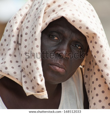 GHANA - MARCH 2, 2012: Portrait of a sad unidentified Ghanaian woman in Ghana, on March 2nd, 2012. People in Ghana suffer from poverty due to the slow development of the country