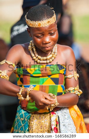 GHANA - MARCH 3, 2012: Portrait of a Ghanaian girl in national colors clothes  dancing the traditional African dance in Ghana, on March 3rd, 2012. Music is the main kind of entertainment in Africa