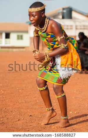 GHANA - MARCH 3, 2012: Ghanaian girl in national colors clothes  dances the traditional African dance in Ghana, on March 3rd, 2012. Music is the main kind of entertainment in Africa