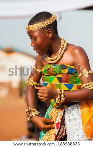 GHANA - MARCH 3, 2012: Ghanaian girl in national colors clothes  dances the traditional African dance in Ghana, on March 3rd, 2012. Music is the main kind of entertainment in Africa