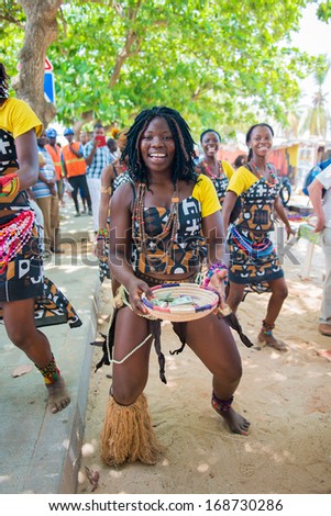 ANGOLA, LUANDA - MARCH 4, 2013: Smiling Angolan woman dances the local folk dance in Angola, Mar 4, 2013. Music is one of the main African entertainments.