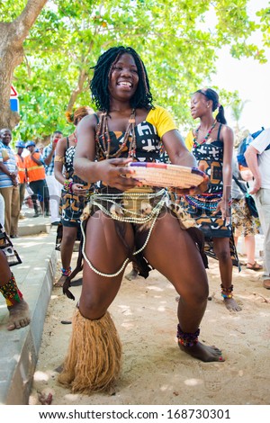 ANGOLA, LUANDA - MARCH 4, 2013: Smiling Angolan woman dances the local folk dance in Angola, Mar 4, 2013. Music is one of the main African entertainments.