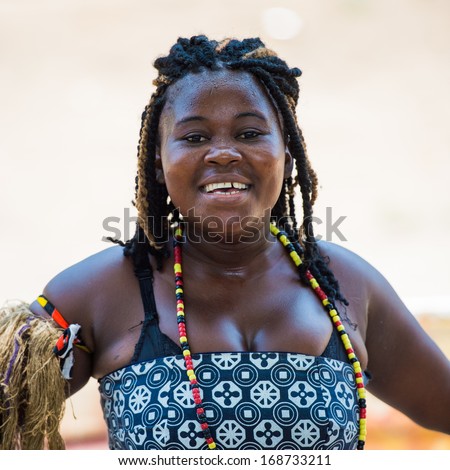 ANGOLA, LUANDA - MARCH 4, 2013:  Angolan sympathetic woman dances the national folk dance in Angola, Mar 4, 2013. Music is one of the main African entertainments.