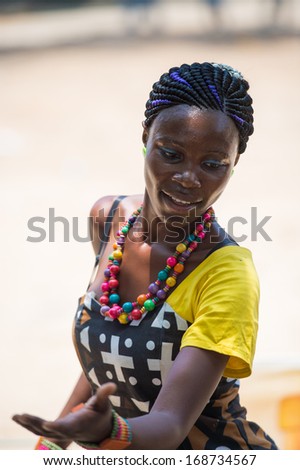 ANGOLA, LUANDA - MARCH 4, 2013:  Angolan beautiful woman dances the national folk dance in Angola, Mar 4, 2013. Music is one of the main African entertainments.