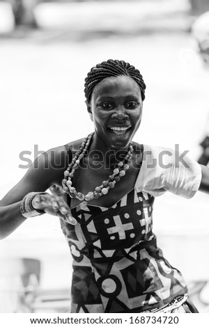 ANGOLA, LUANDA - MARCH 4, 2013:  Angolan beautiful woman dances the national falk dance in black and white in Angola, Mar 4, 2013. Music is one of the main African entertainments.