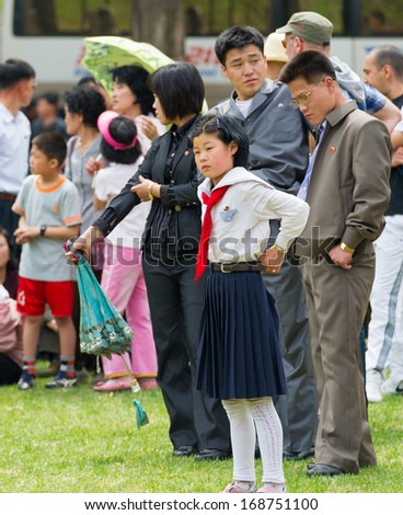 NORTH KOREA - MAY 1, 2012: Pioneer Korean girl during the celebration of the International Worker\'s Day in N.Korea, May 1, 2012. May 1 is a national holiday in 80 countries